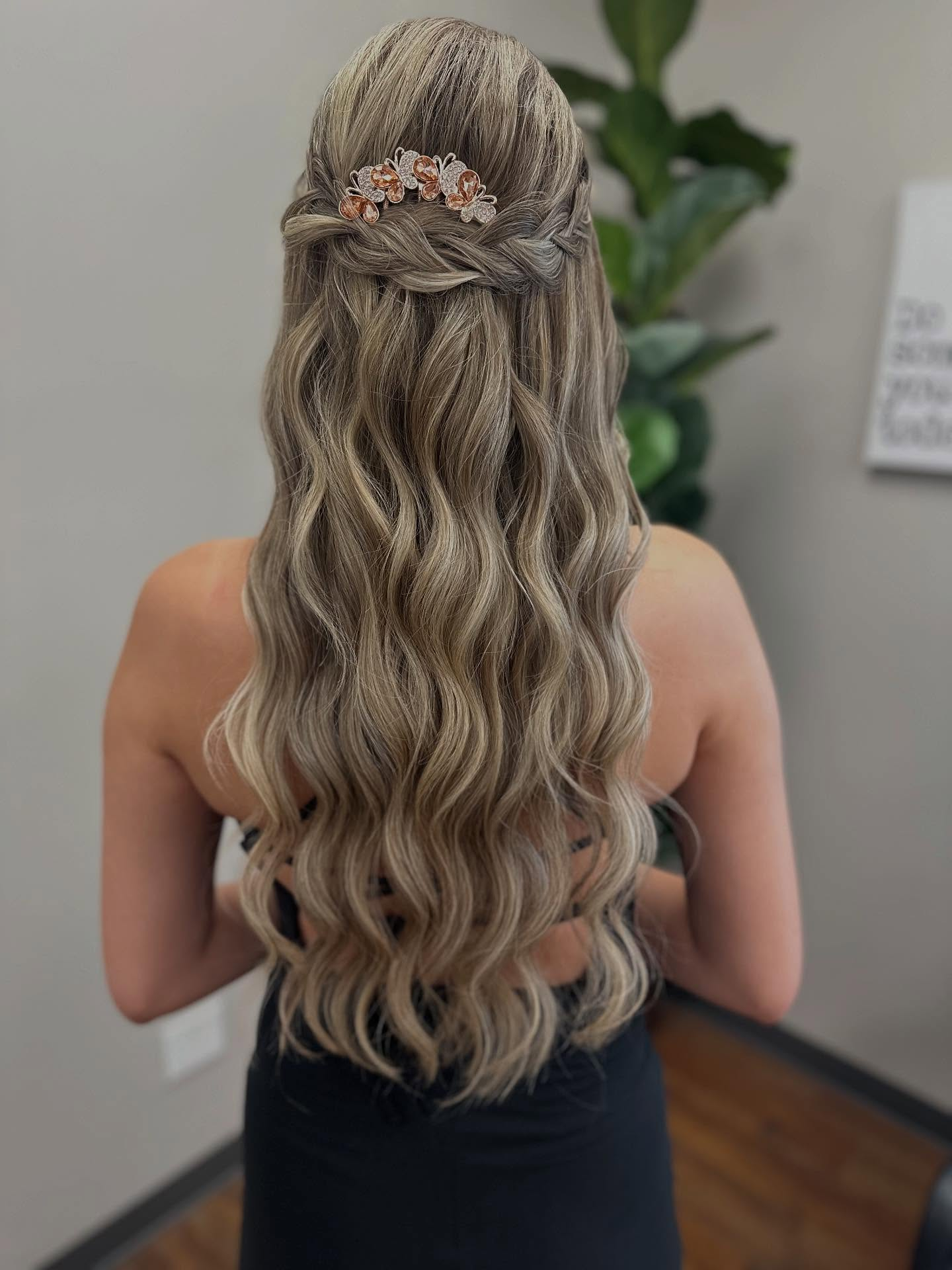 Half-up formal hairstyle with soft blonde waves