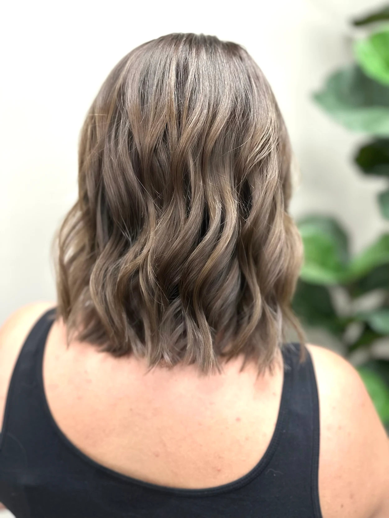 Glossy ash brunette long bob with polished texture