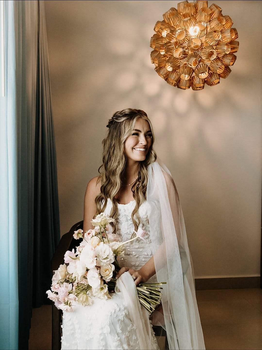 Bride with styled waves holding a bouquet